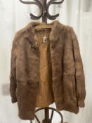 A LIGHT BROWN FUR JACKET.