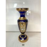 A BOHEMIAN BLUE AND GOLD DECORATED VASE WITH FLORAL ENCRUSTED DECORATION, 40 CMS.