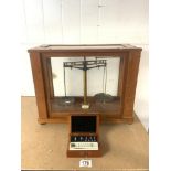A SET OF CHEMISTS SCALES IN A GLAZED MAHOGANY CABINET, AND SET WEIGHTS IN CASE MAKER A. GALLENKAMP &