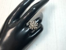 A 750 HALLMARKED GOLD AND DIAMOND SET FLOWER HEAD RING, SIZE, M AND HALF, 5.3 GMS.