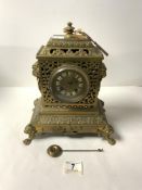 A LATE NINETEENTH CENTURY FRENCH ORNATE BRASS MANTEL CLOCK, WITH LION RING HANDLES AND CLAW FEET,