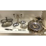 TWO SILVER-PLATED SALVERS, PLATED CONDIMENTS, CANDELABRA, AND OTHER PLATED WARES.