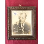 A PORTRAIT PHOTOGRAPH OF BING CROSBY, IN A CARVED FRAME. 22 X 26 CM.