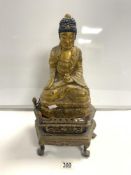 A GILDED WOODEN STATUE OF A BUDDHA, 30 CMS, ON A CARVED STAND.