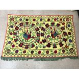 SUZANI EMBROIDERED MULTI-COLOURED WALL HANGING ON YELLOW BACKGROUND WITH CENTRAL BIRD DECORATION