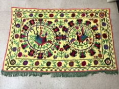 SUZANI EMBROIDERED MULTI-COLOURED WALL HANGING ON YELLOW BACKGROUND WITH CENTRAL BIRD DECORATION