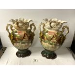 A PAIR OF LATE VICTORIAN CERAMIC VASE DECORATED WITH CATTLE AND MILKMAID, 35 CMS. A/F.