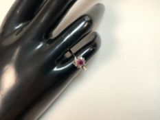 A 18CT HALLMARKED GOLD RUBY SET LADIES DRESS RING, SIZE I AND A HALF, 3.2 GMS.