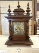 A GERMAN MAHOGANY AND WALNUT ARCHITECTURAL DESIGN MANTEL CLOCK, WITH SILVERED CHAPTERED DIAL,