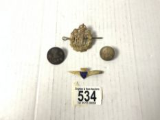 A ROYAL FLYING CORPS HAT BADGE, TWO BUTTONS AND AN ENAMEL BOAC BADGE.