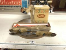 ANIMAL HOOF FOOT HANDLED CARVING SET AND CHEESE KNIFE SET WITH BOARD, AND A PATES TIN.