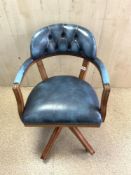 A REPRODUCTION BLUE LEATHER SWIVEL COURT CHAIR.