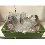 A QUANTITY OF CUT GLASSWARE - INCLUDES DECANTERS, VASES, CHAMPAGNE FLUTES AND MORE.