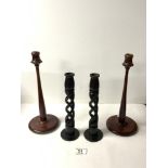 A PAIR OF MAHOGANY TURNED CANDLESTICKS, 31 CMS AND A PAIR OF WOODEN OPEN BARLEY TWIST CANDLESTICKS.