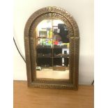 A MEXICAN COPPER AND BRASS DOME TOP WALL MIRROR, 39 X 58 CM.