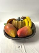 A WOODEN BOWL OF PAINTED FAUX FRUIT AND VEG.