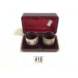 PAIR OF HALLMARKED SILVER ENGINE TURNED NAPKIN RINGS DATED 1942 BY H BROS CASED