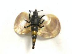 A VINTAGE BRONZE MODEL OF A LOCUST WITH MOTHER O PEARL WINGS. 20 CMS,