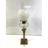 A LATE VICTORIAN BRASS CORINTHIAN COLUMN OIL LAMP, WITH CUT GLASS RESERVOIR AND WHITE GLASS SHADE,