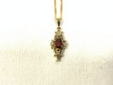 9 CARAT GOLD NECKLACE WITH A 9 CARAT GOLD PENDANT WITH DIAMONDS AND GARNET