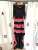 A PINK AND BLACK LACE FLAMENCO DRESS, WORN BY SUSSANA OSMONDI, WITH PHOTOGRAPHS SHOWING HER