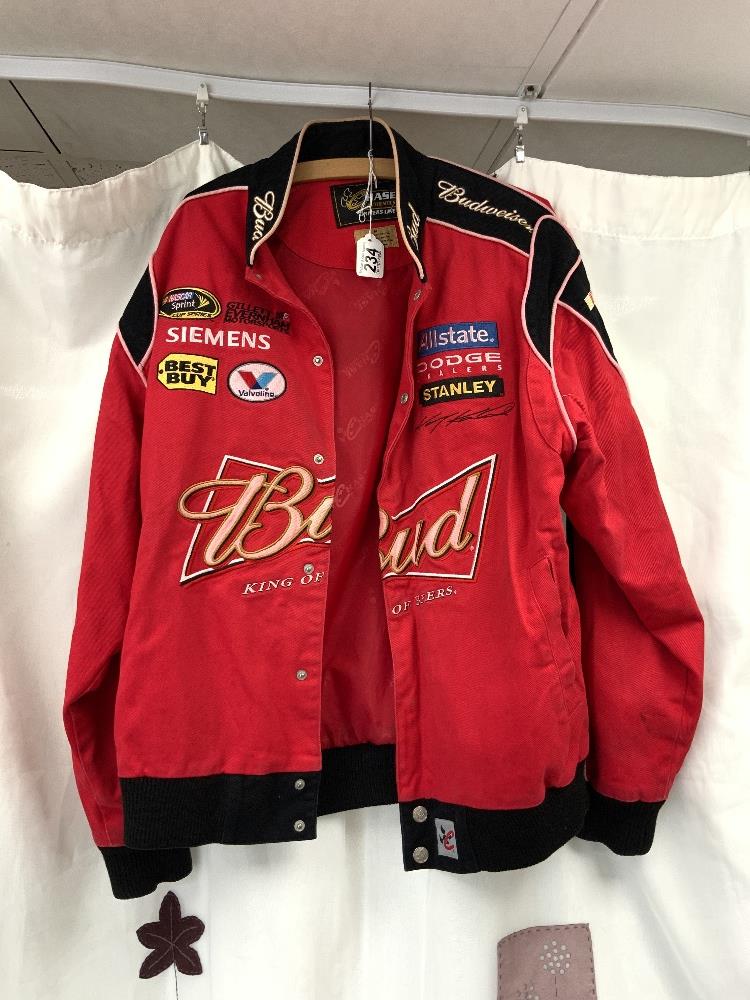 A CHASE DRIVERS LINE RED JACKET WITH SPONSORS LOGOS. SIZE M.