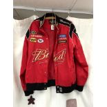 A CHASE DRIVERS LINE RED JACKET WITH SPONSORS LOGOS. SIZE M.