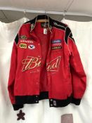 A CHASE DRIVERS LINE RED JACKET WITH SPONSORS LOGOS. SIZE M.