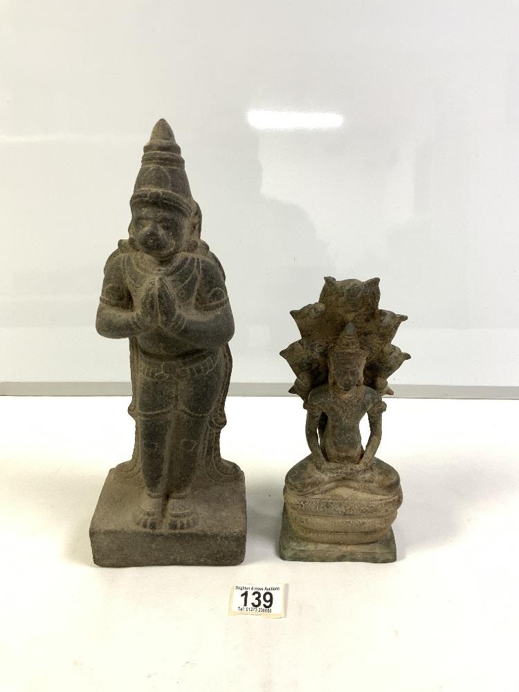 ANTIQUE IRON FIGURE OF A DEITY, 24 CM, AND A STONE PRAYING FIGURE.