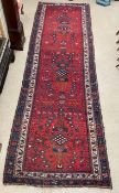 A RED AND BLUE GROUND TURKISH RUNNER CARPET, 400X120 CMS.