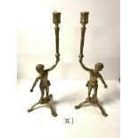 A PAIR OF BRASS FIGURAL CANDLE STICKS, 40 CMS.