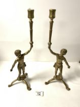 A PAIR OF BRASS FIGURAL CANDLE STICKS, 40 CMS.