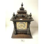 A LATE VICTORIAN CARVED WALNUT AND PINE CHIMING MANTEL CLOCK, WITH BRASS DIAL AND PILLAR MOUNTS,