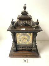 A LATE VICTORIAN CARVED WALNUT AND PINE CHIMING MANTEL CLOCK, WITH BRASS DIAL AND PILLAR MOUNTS,