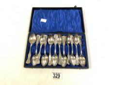 A SET OF TWELVE SWEDISH MARKED ORNATE SILVER TEA SPOONS AND CASE. 284 GMS.