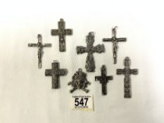 SEVEN EMBOSSED WHITE METAL CROSSES WITH SIMILAR MASK PENDANT