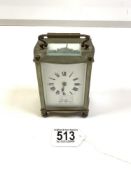 BRASS CARRIAGE CLOCK OF SERPENTINE OUTLINE WITH WHITE ENAMEL DIAL - WARREN OF EASTBOURNE MADE IN