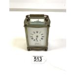 BRASS CARRIAGE CLOCK OF SERPENTINE OUTLINE WITH WHITE ENAMEL DIAL - WARREN OF EASTBOURNE MADE IN