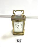 BRASS CARRIAGE CLOCK OF SERPENTINE OUTLINE WITH WHITE ENAMEL DIAL12CM W/O