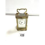 BRASS CARRIAGE CLOCK OF SERPENTINE OUTLINE WITH WHITE ENAMEL DIAL12CM W/O