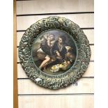 A PORTUGESE EMBOSSED PORCELAIN WALL PLATE, DECORATED WITH BOYS AND BASKET OF FRUIT, 42 CMS