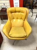 A 1970s BUTTONED LEATHERETTE SWIVEL ARMCHAIR.