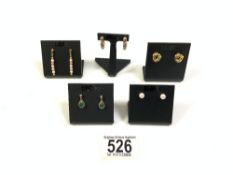 FOUR PAIRS OF 375 HALLMARKED GOLD EARRINGS, 1 PAIR SET WITH EMERALDS, AND A PAIR OF YELLOW METAL