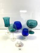 LARGE BLUE GLASS BRANDY BALLOON, TWO OTHERS, AND A TALL GREEN GLASS 32 CMS, AND TWO MORE PIECES.