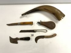 A STEEL MILITARY BONE SAW, FRENCH FISHING KNIFE, TWO VINTAGE BILLHOOK KNIVES, A POWDER FLASK, AND