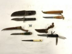 A VINTAGE MULTI PURPOSE DAGGER, MADE BY DECORA SELINGEN GERMANY, AND FOUR OTHER DAGGERS.