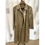 A BEIGE BURBERRY OVER COAT.