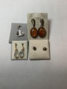 A PAIR OF SILVER AMBER SET EARRINGS, TWO OTHER PAIRS AND A CRYSTAL PENDANT.