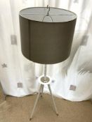 A MODERN WHITE WOODEN TRIPOD LAMP STAND AND SHADE.