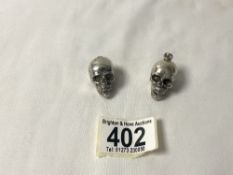 TWO WHITE METAL ARTICULATED SKULL PENDANTS, 41 GMS.